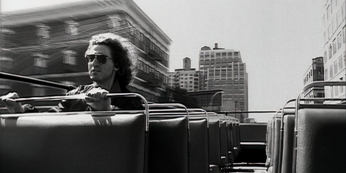 timothy levitch holds on atop a nyc tour bus