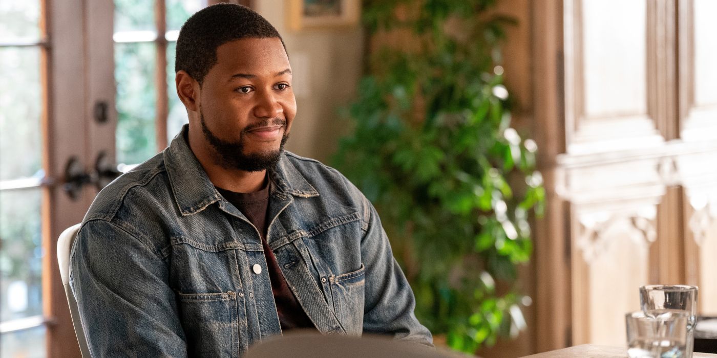 Luke Tennie smiling at a table in Shrinking Season 2