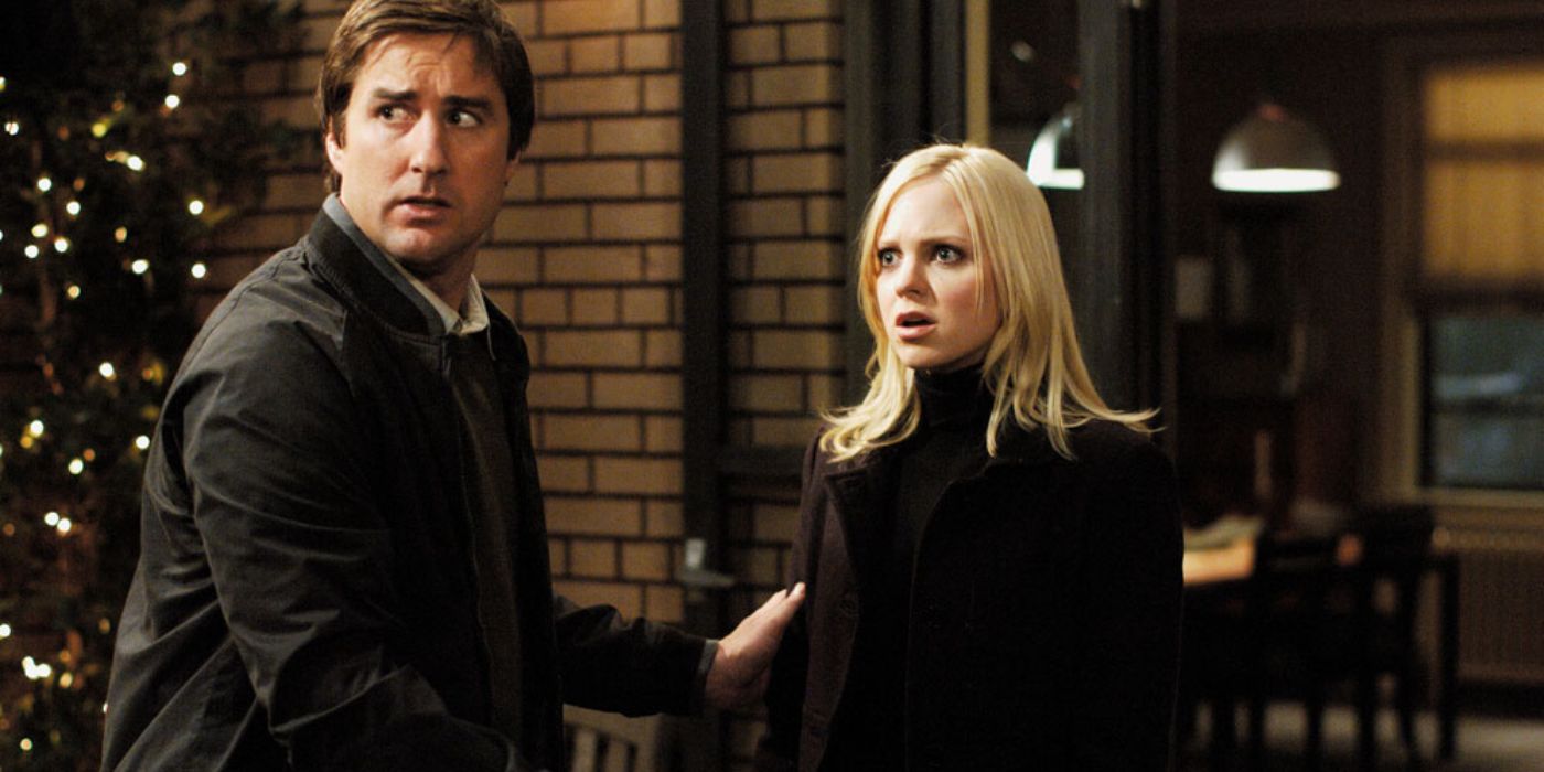 Luke Wilson and Anna Faris are looking shocked while observing something off-screen, behind Luke Wilson and in front of Anna Faris