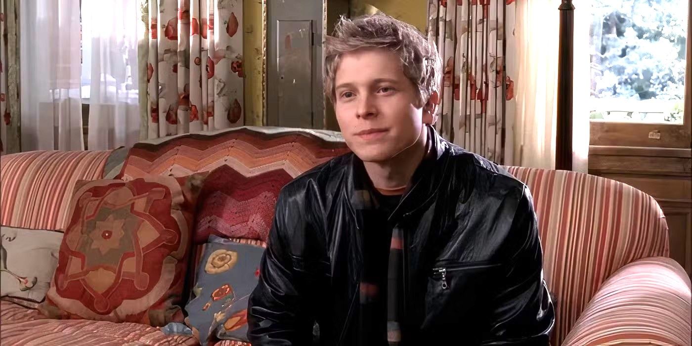 Matt Czuchry as Logan Huntzberger sits on a couch in The Dragonfly Inn in Gilmore Girls.