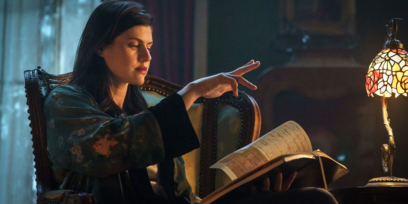 Alexandra Daddario as Rowan casting a spell over a book in a darkened room