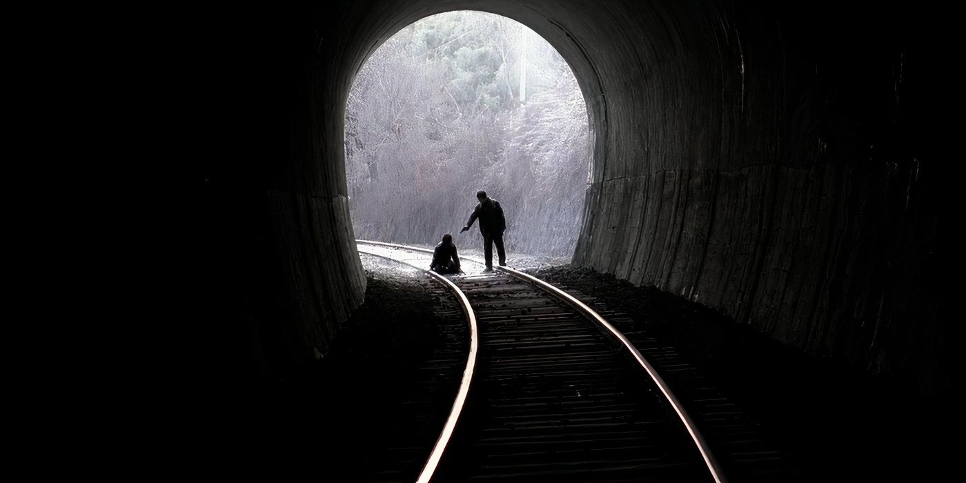 A man aiming a gun at another man at the end of a tunnel in Memories of a Murder