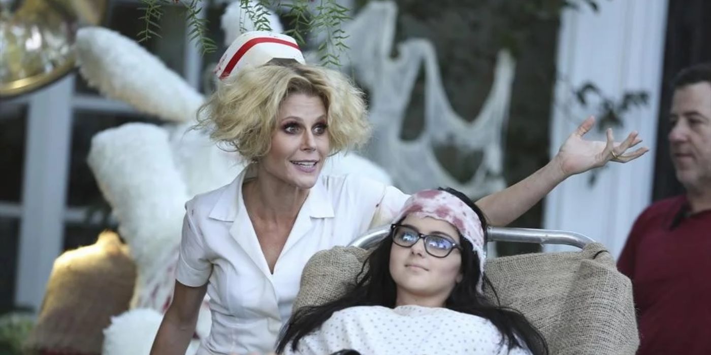 Claire dressed as an undead nurse and Alex lying on a gurney with a fake bandage on her head in Modern Family.