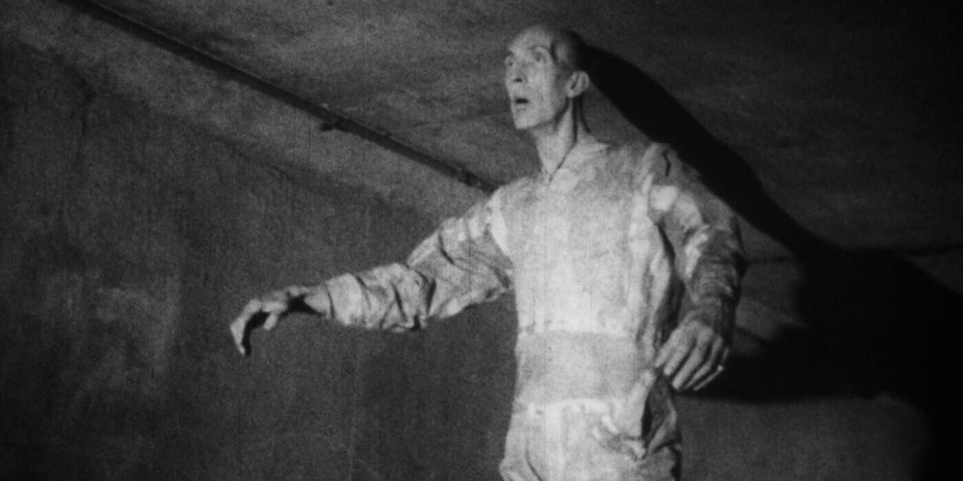 A mysterious, lanky man wearing bandages in a hallway in 'Monster a Go-Go!' 