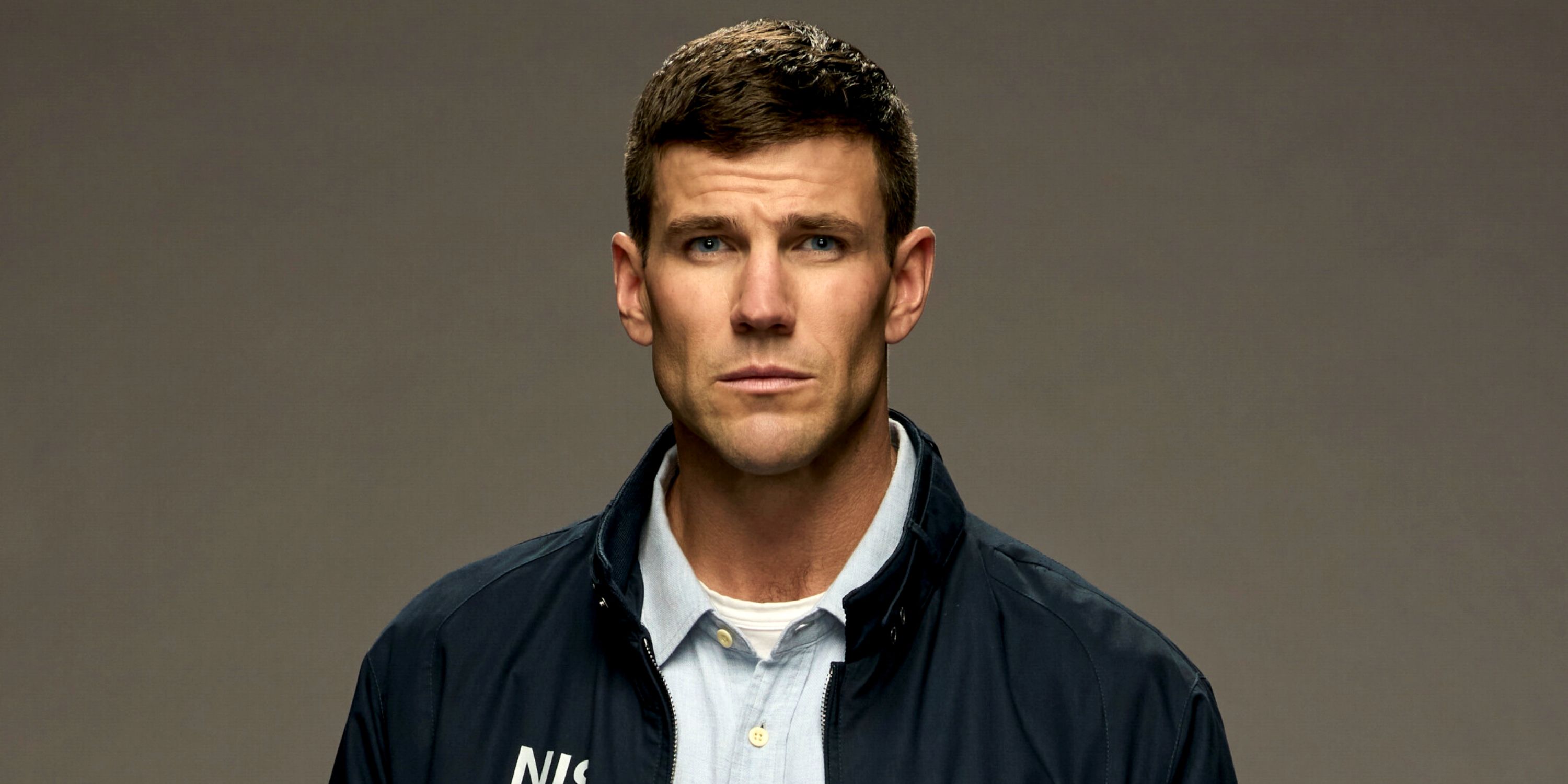 Austin Stowell as Special Agent Leroy Jethro Gibbs in his NIS jacket in a CBS promo photo for NCIS: Origins