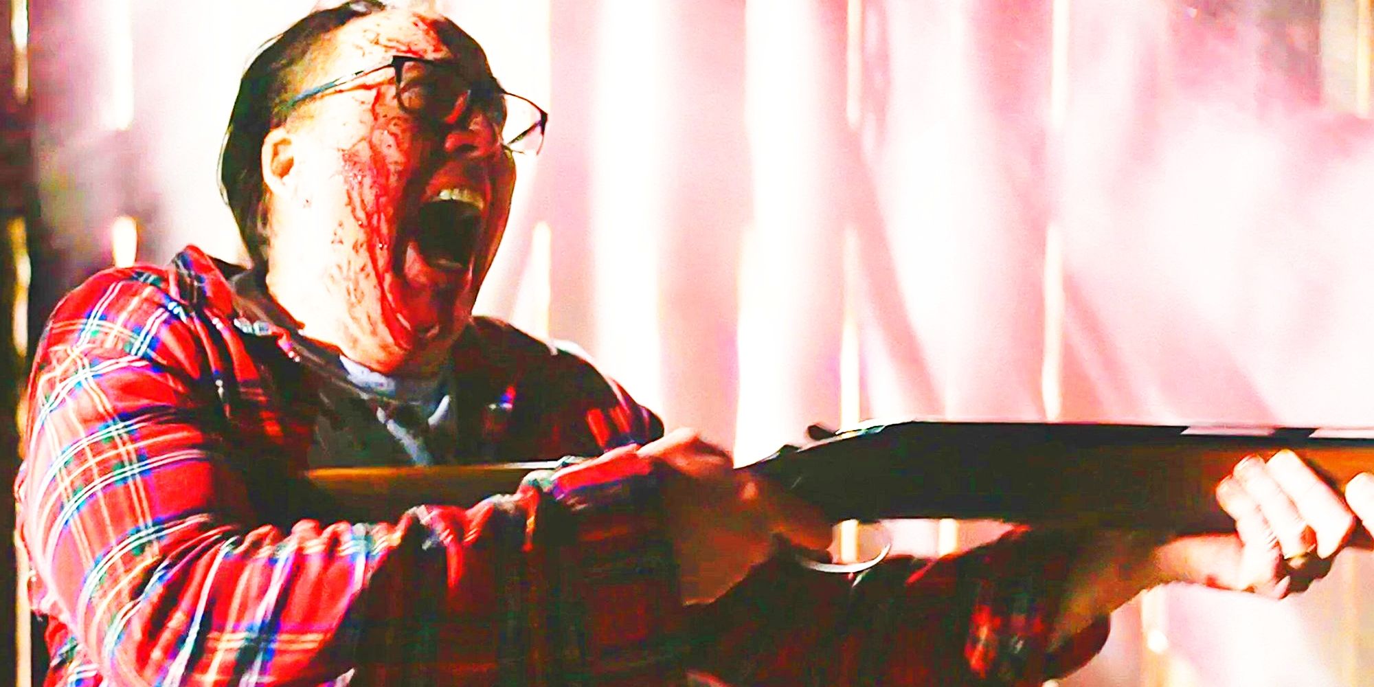 Nathan Gardner, played by actor Nicolas Cage, screaming while covered in blood and holding a shotgun in Color Out Of Space.