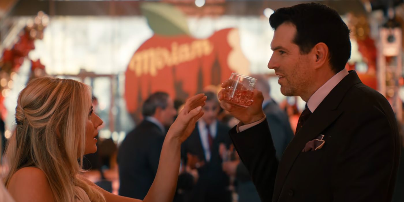 Morgan (Justine Lupe) reaching for Sasha's (Timothy Simons) glass at a bat mitzvah in Nobody Wants This