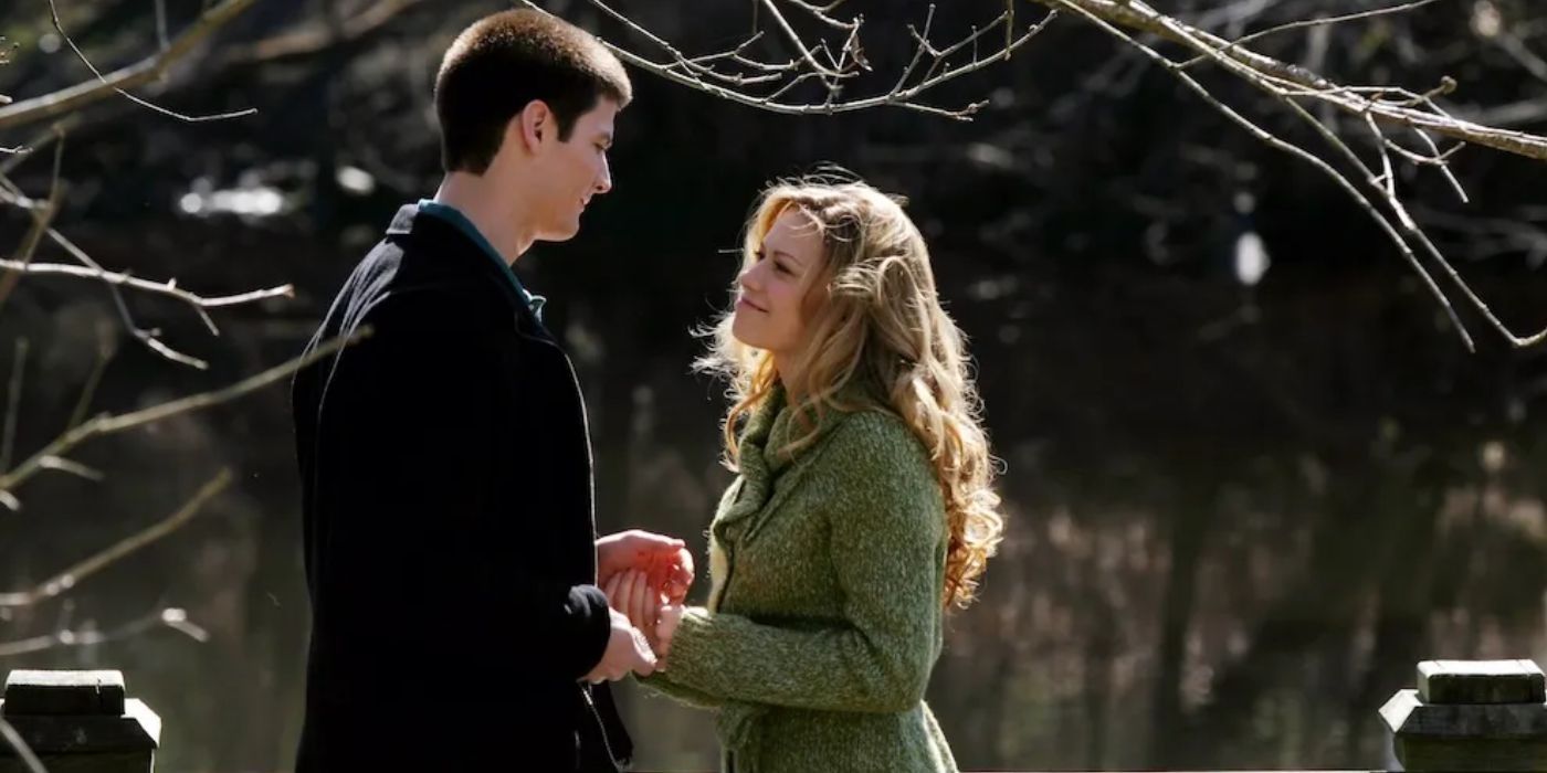Haley (Bethany Joy Lenz) and Nathan (James Lafferty) holding hands near a lake in &lsquo;One Tree Hill&rsquo; Season 3.