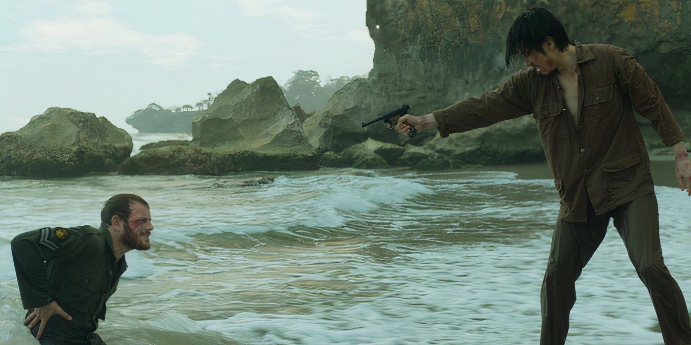 Man pointing a gun at another in the ocean