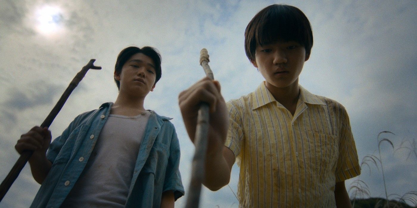 Pachinko Season 2 Episode 4 image featuring two young boys poking something on the ground with sticks