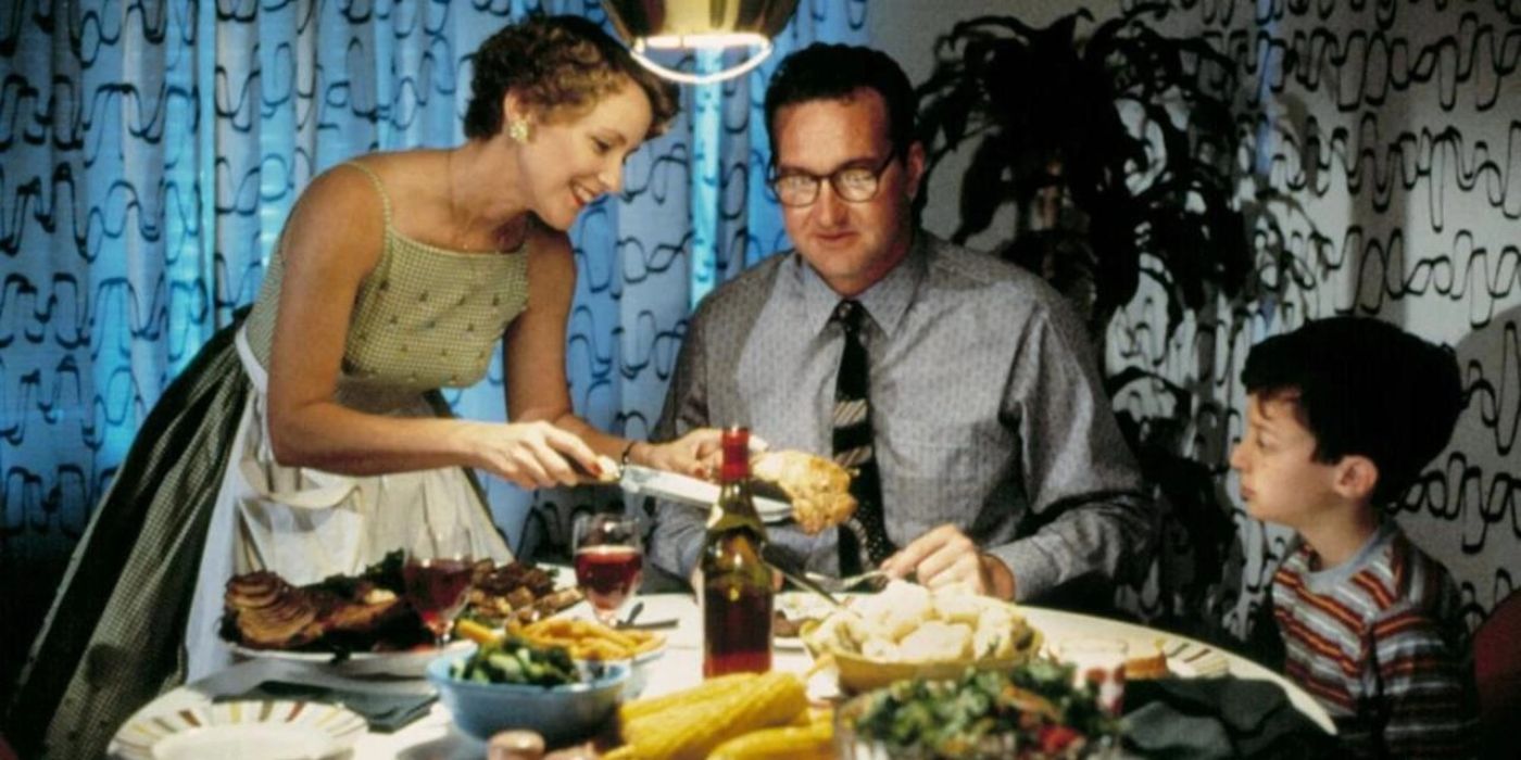 A boy sits at a dinner table with his parents as they eat a robust meal in Parents (1989).