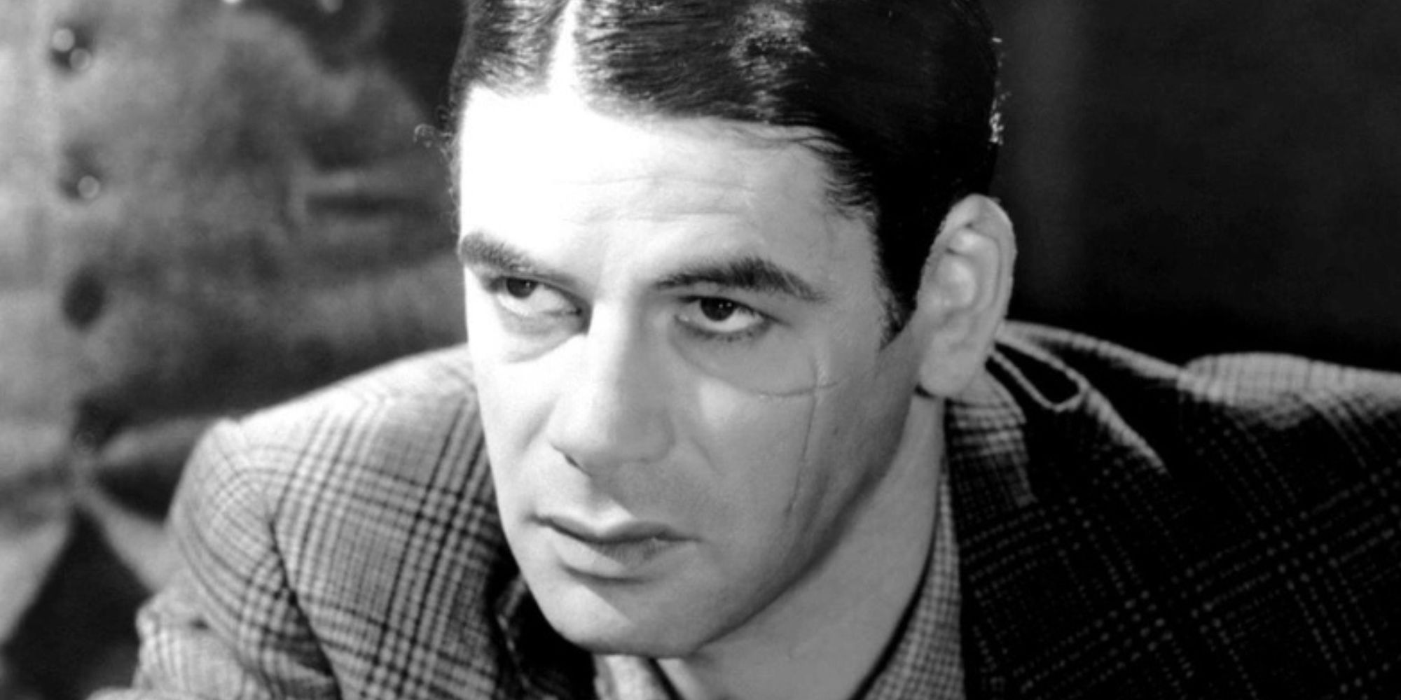 Tony Camonte looking intently with a hardened expression in Scarface (1932)