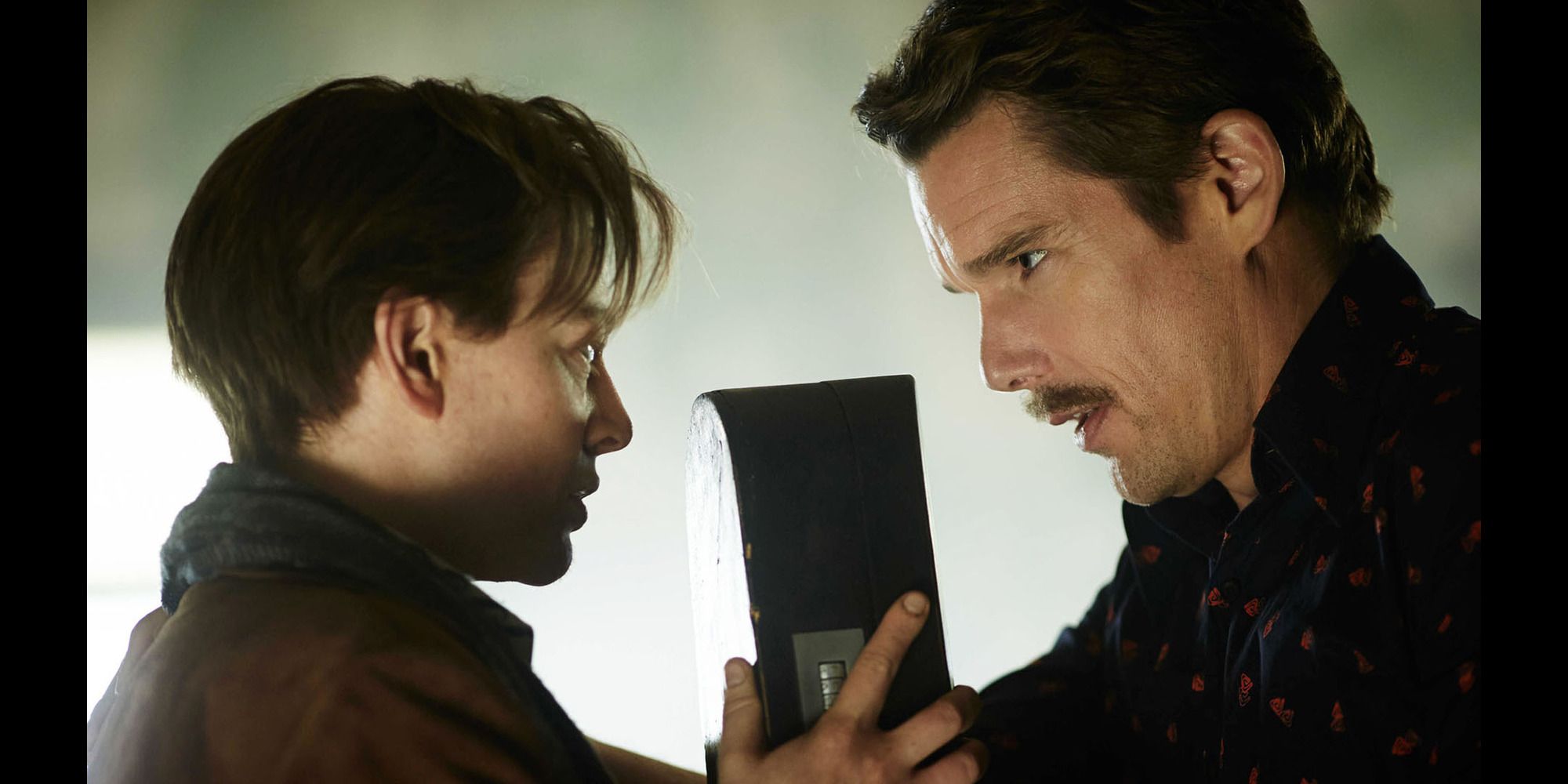 John (Sarah Snook) and the Barkeep (Ethan Hawke) figure out a plan in Predestination.