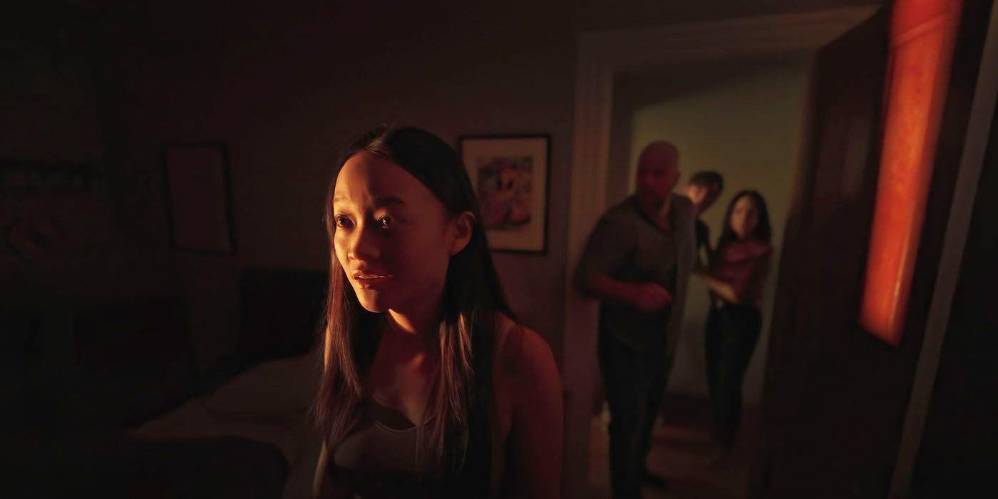 Callina Liang looking scared while other people stand in the doorway in Presence