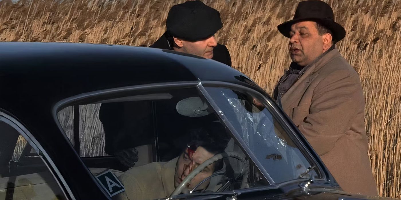 Richard S Castellano and another man stand outside a car where a man has been shot in The Godfather.