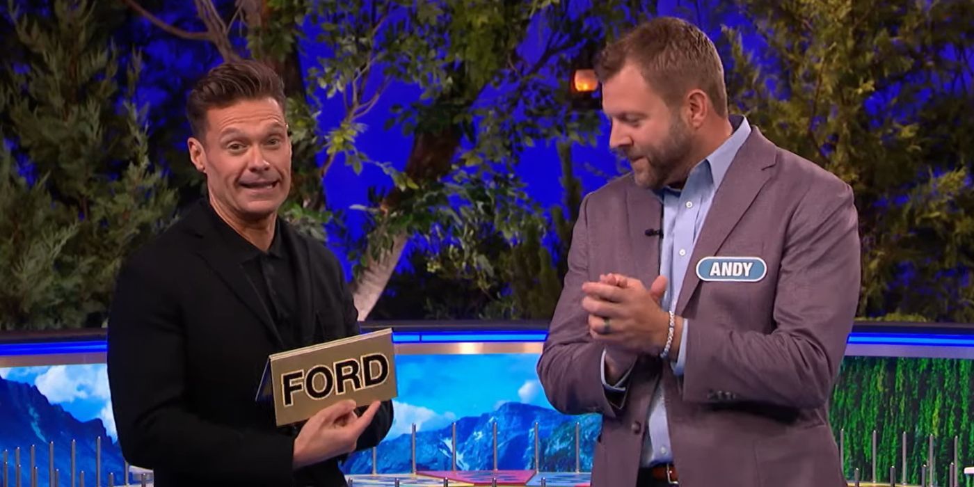 Ryan Seacrest holds up a bonus card for a Ford vehicle as contestant Andy applauds on Wheel of Fortune.