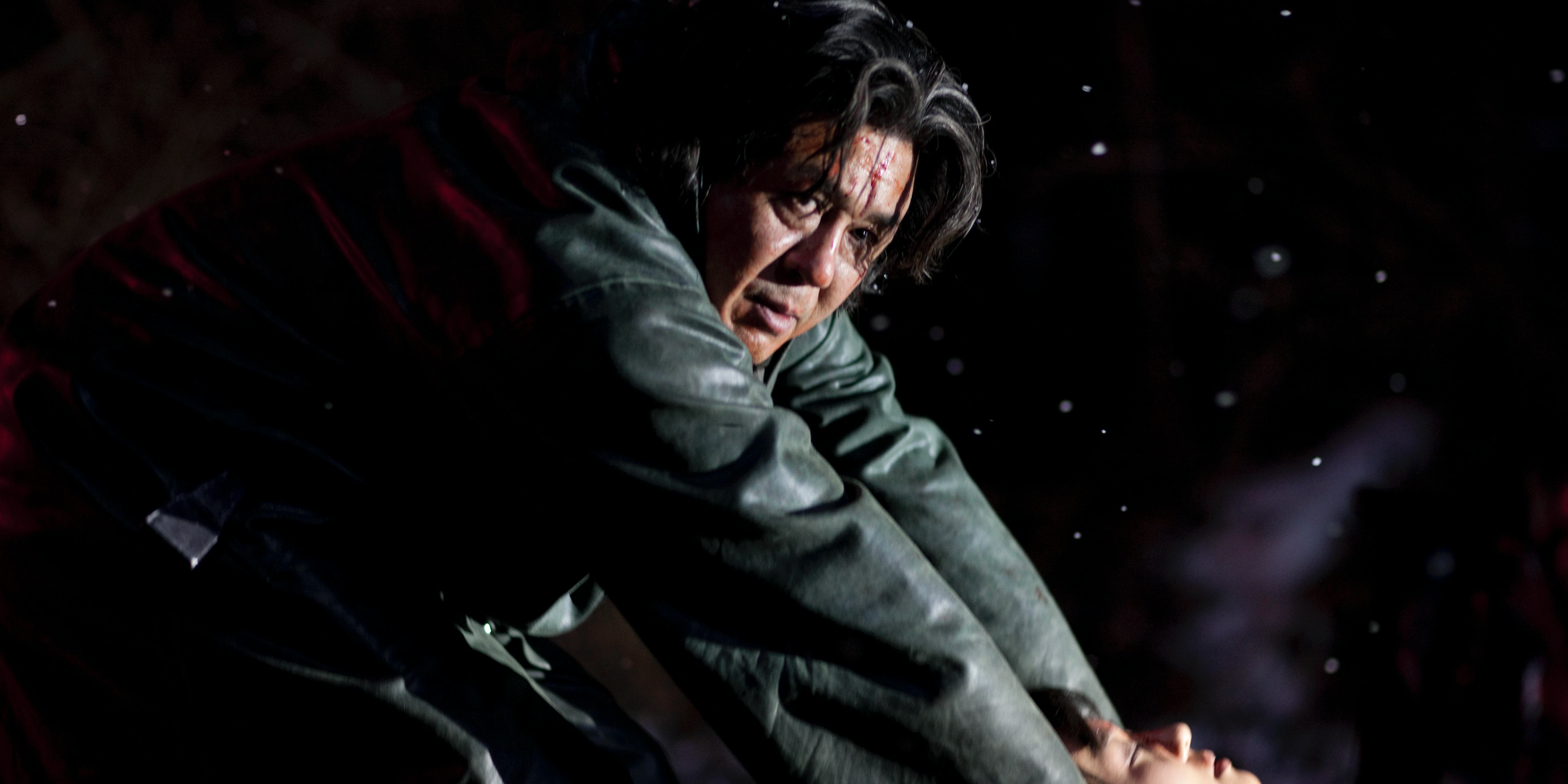 A man at night looking intently off-camera in i-saw-the-devil