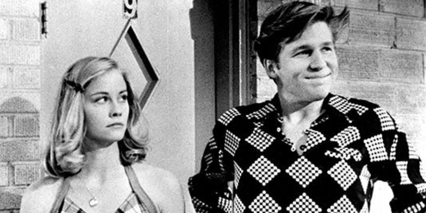 Cybill Shepherd and Jeff Bridges as Jacy and Duane wearing a checkered shirt and tank top outside a door in 'The Last Picture Show'
