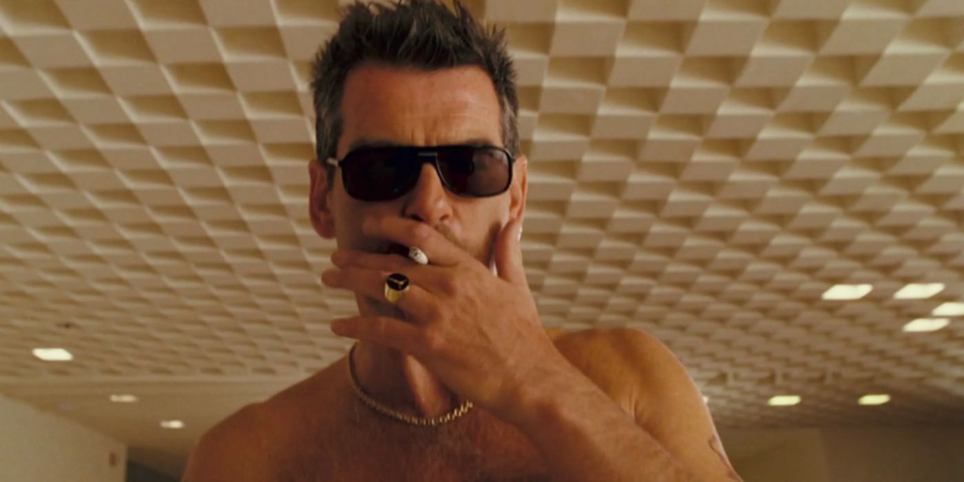 Pierce Brosnan as Julian Noble shirtless smoking a cigarette and wearing sunglasses in 'The Matador'