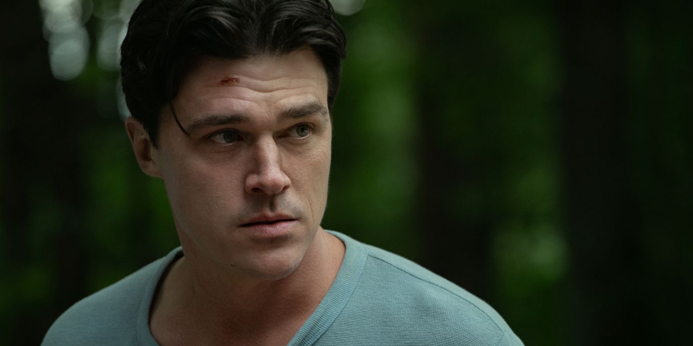 Finn Wittrock as Richard, standing in the forest with a cut on his forehead in Netflix's Don't Move