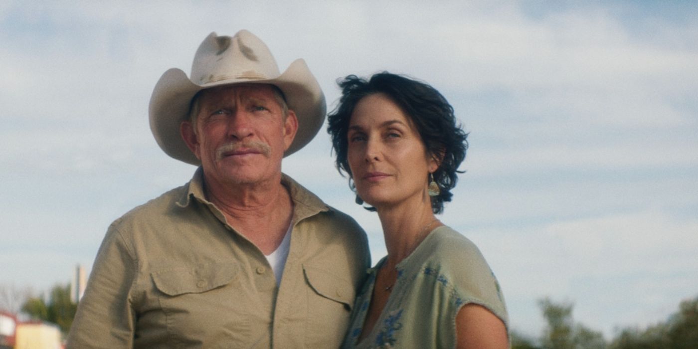 Thomas Haden Church and Carrie-Ann Moss as Merle and Faye standing outside in a cowboy hat and green shirt in 'Accidental Texan'