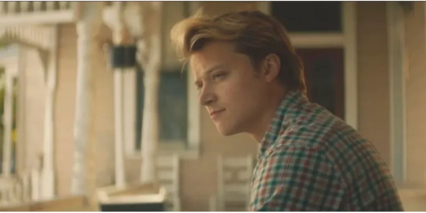 Rudy Pankow as Erwin wearing a flannel shirt standing outside on a porch in 'Accidental Texan'