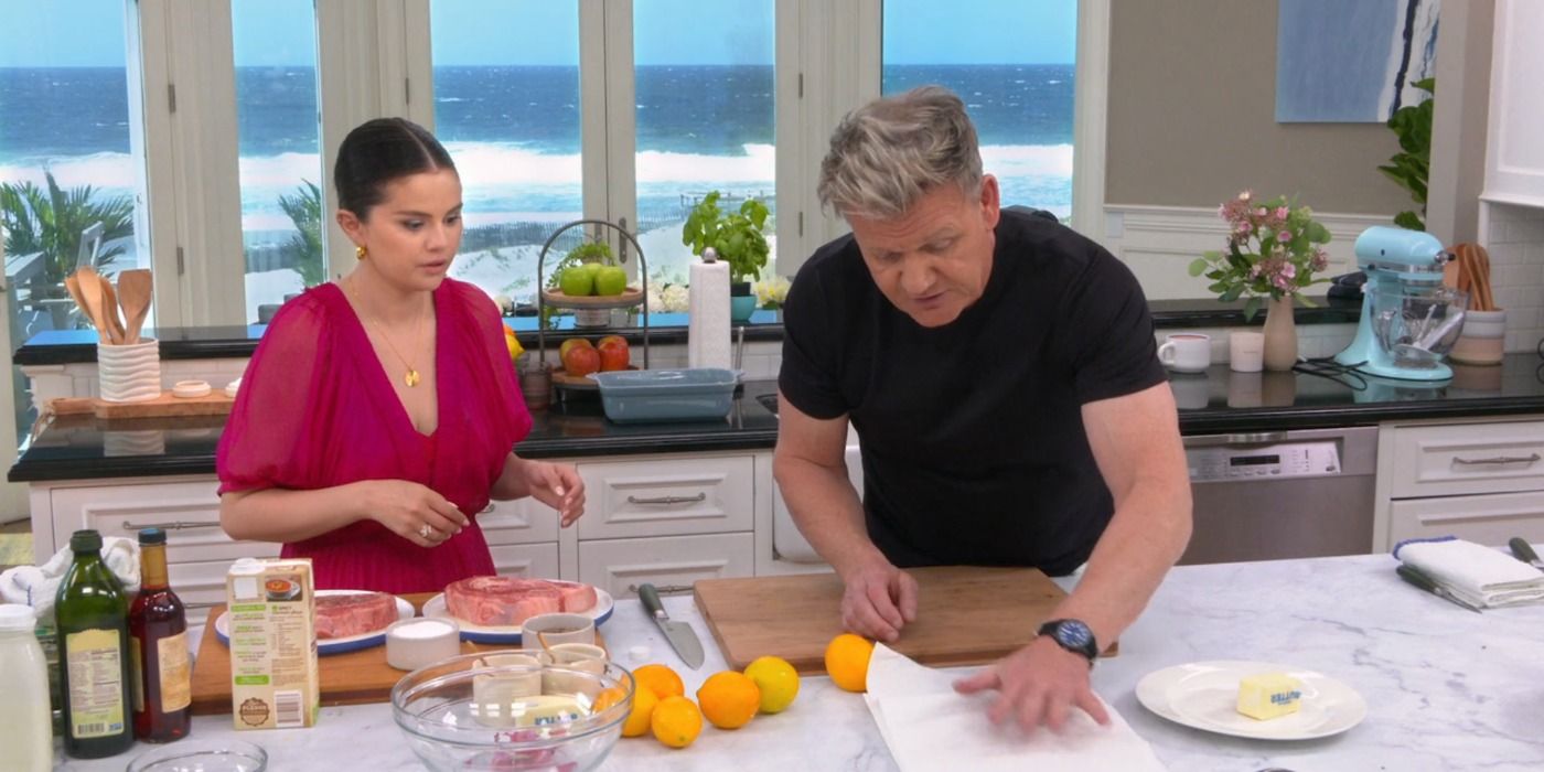 Selena Gomez cooking alongside Gordon Ramsay as they look concentrated in cooking their recipe.