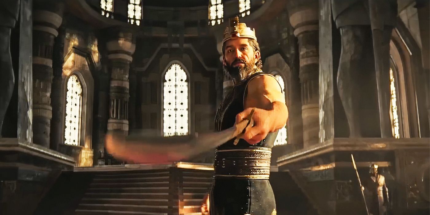 A man in a crown points a sword toward camera