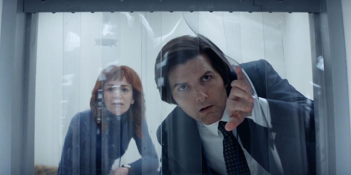 Britt Lower and Adam Scott peeping through plastic coverings as Helly and Mark S in Severance Season 2.