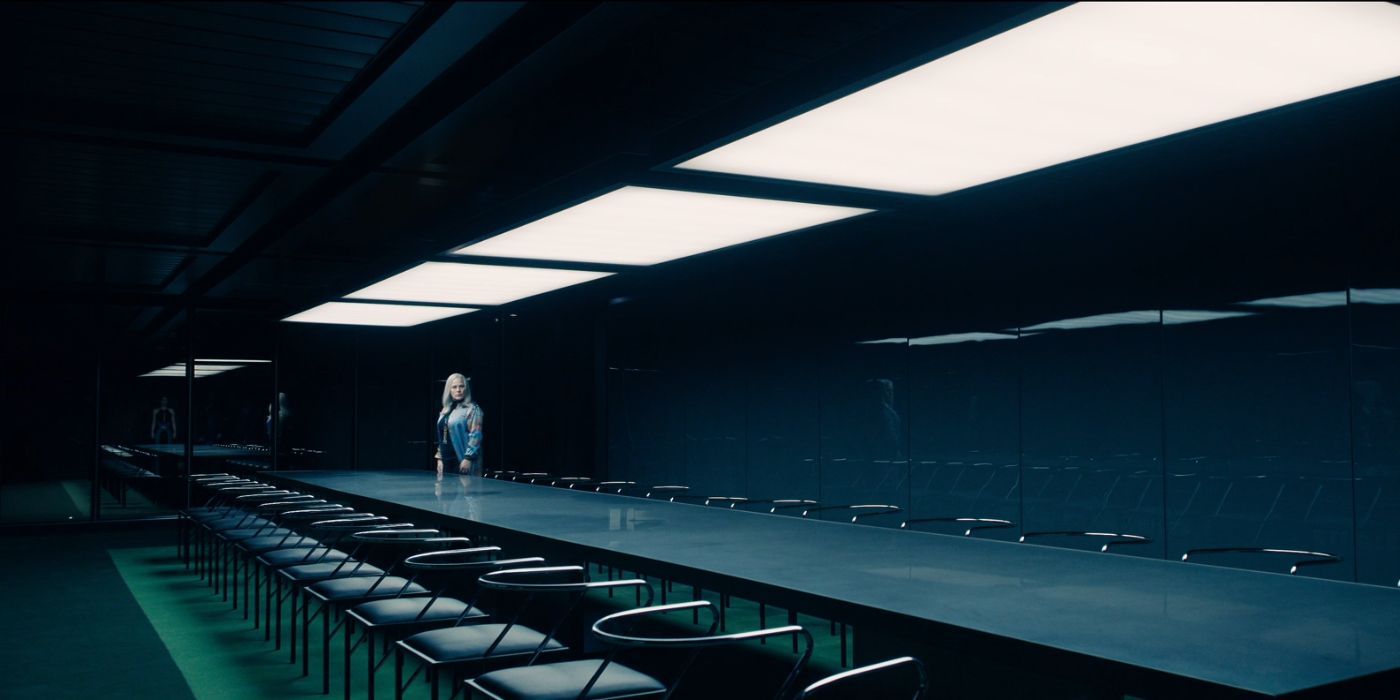 Patricia Arquette as Harmony Cobel, standing in an empty board room, in Severance Season 2.