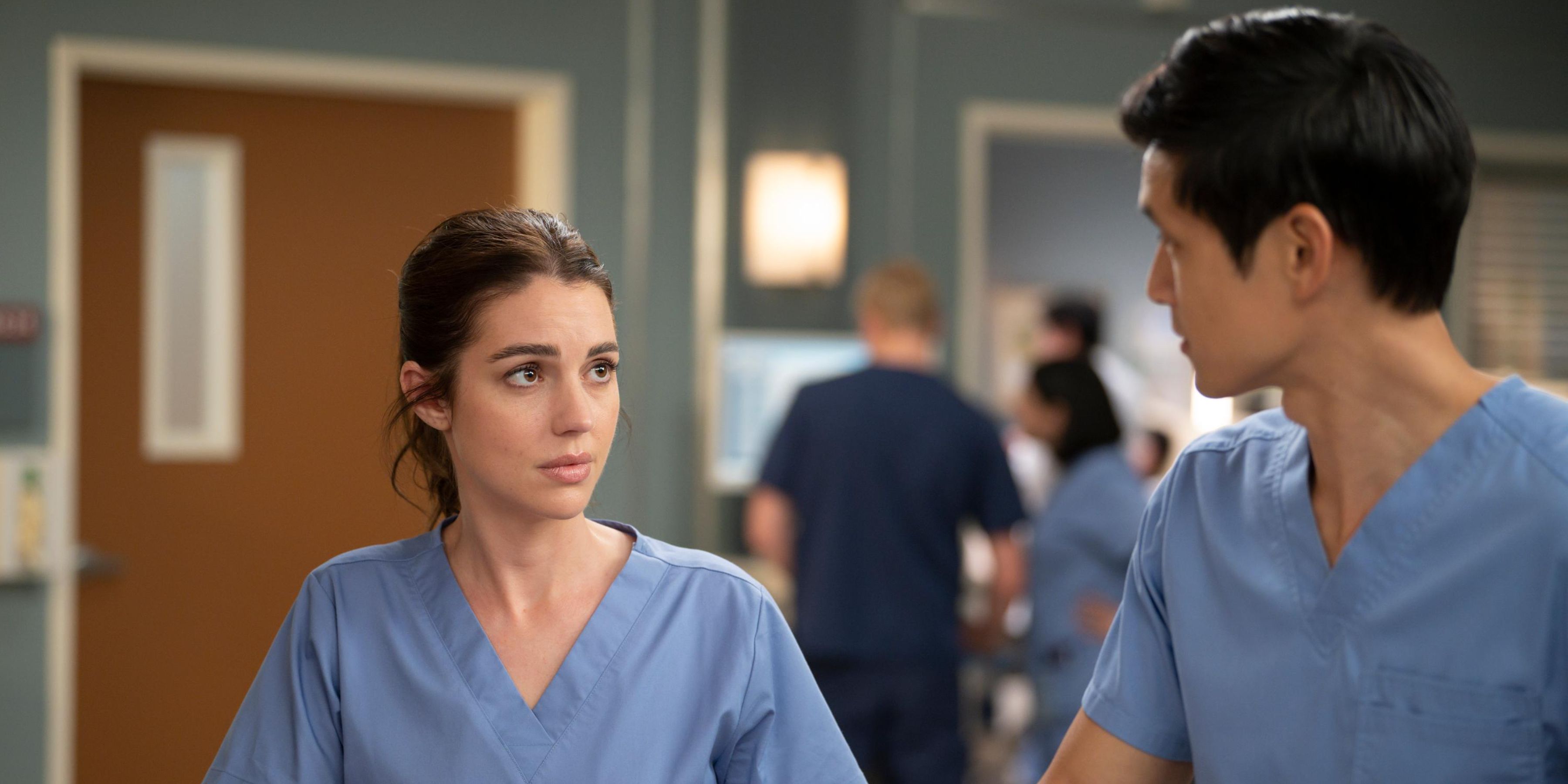 Adelaide Kane and Harry Shum Jr. looking at each other as Jules and Blue in 'Grey's Anatomy' Season 20