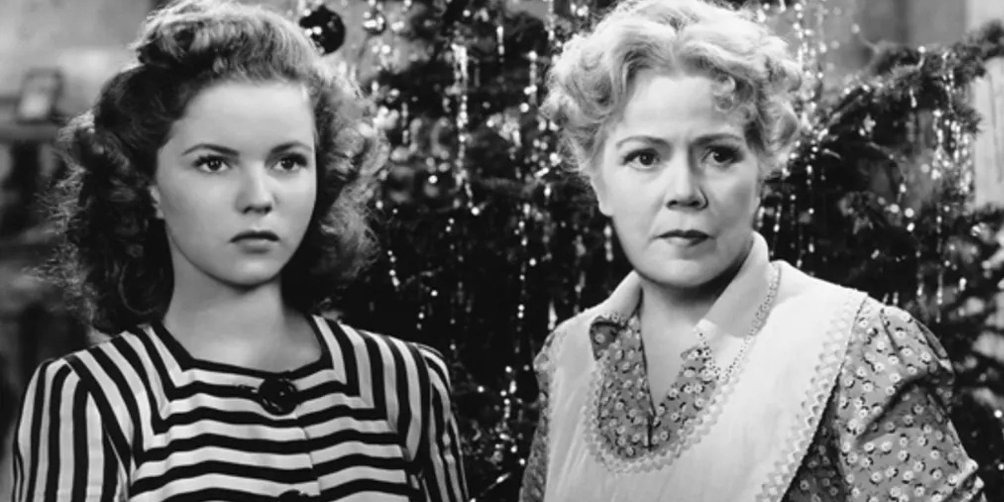 Shirley Temple standing next to Spring Byington in front of a Christmas tree looking forward in I'll Be Seeing You (1944)