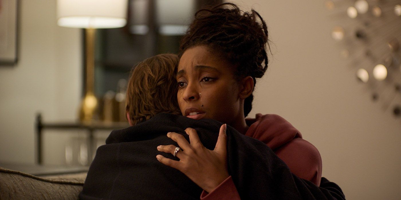 Jessica Williams hugging someone and crying over their shoulder in Shrinking