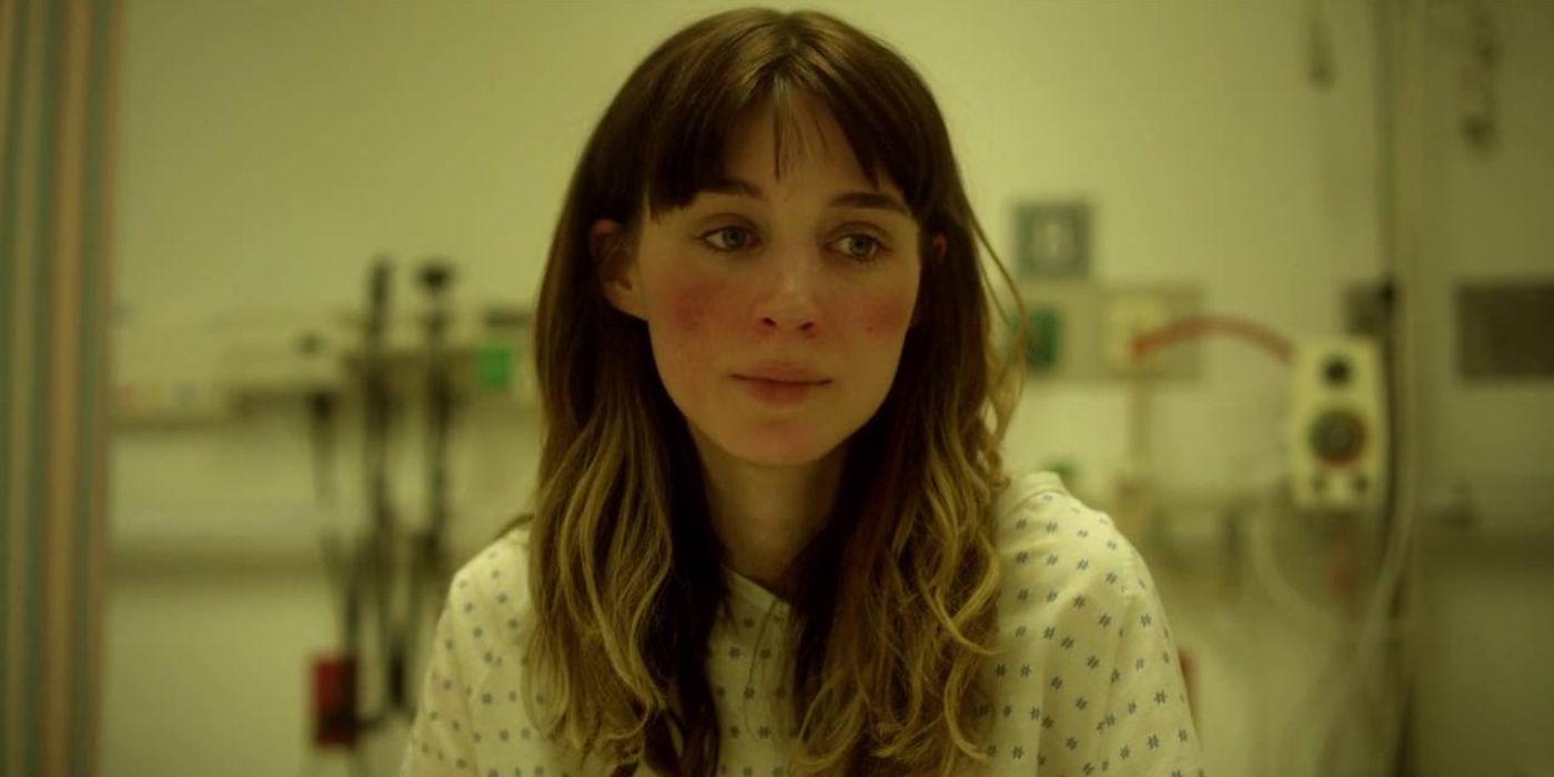 Emily Taylor (Rooney Mara) sits on a hospital bed wearing white scrubs in 'Side Effects' (2013).