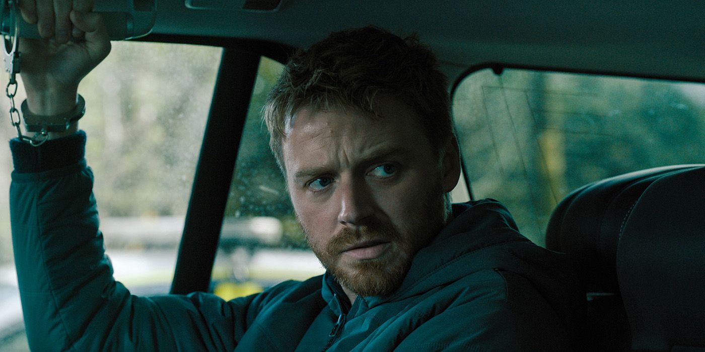 Jack Lowden handcuffed in the backseat of a car in Slow Horses Season 4