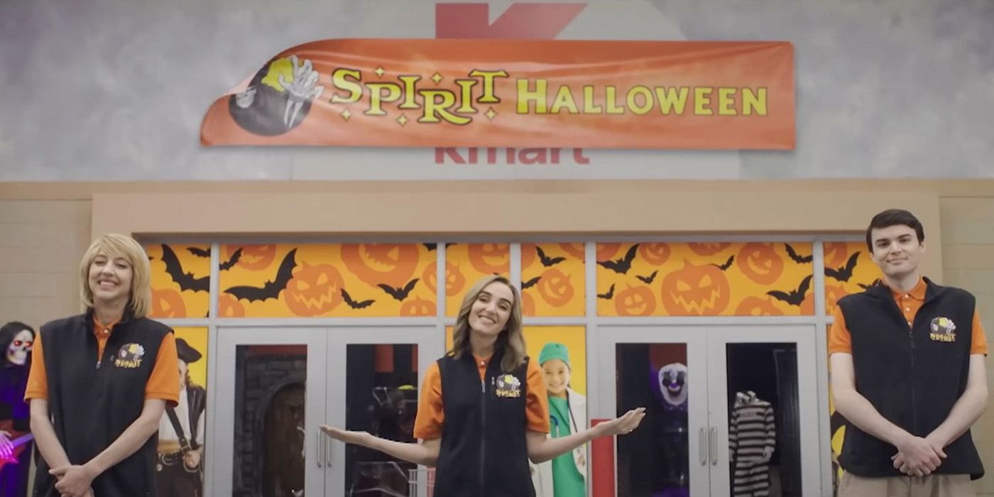 Three cast members from SNL standing in front of a Spirit Halloween store, the sign loosely covering a Kmart.