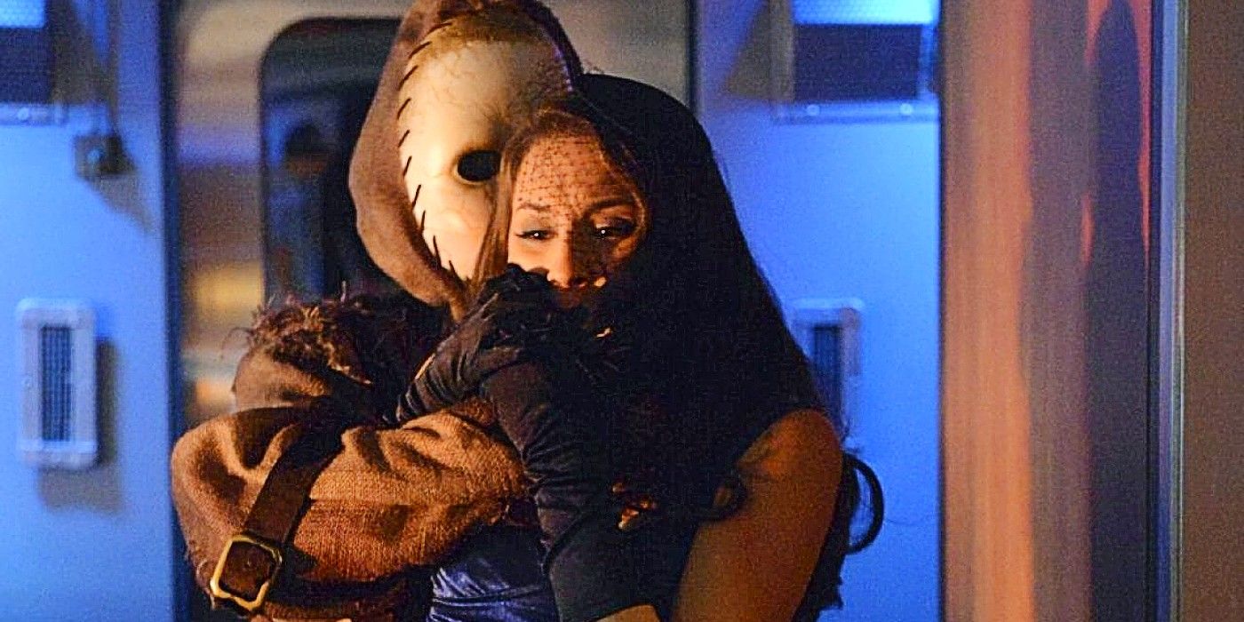 A person in a baby mask covering Spencer Hastings' mouth in Pretty Little Liars' Season 3 Halloween special