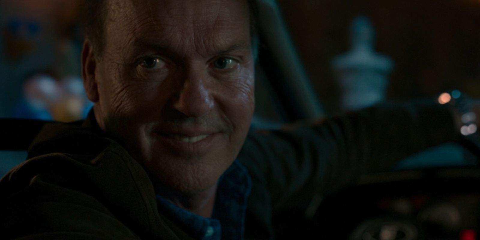 Adrian Toomes, AKA the Vulture, smiles while looking into the backseat of his car in &lsquo;Spider-Man: Homecoming&rsquo;.