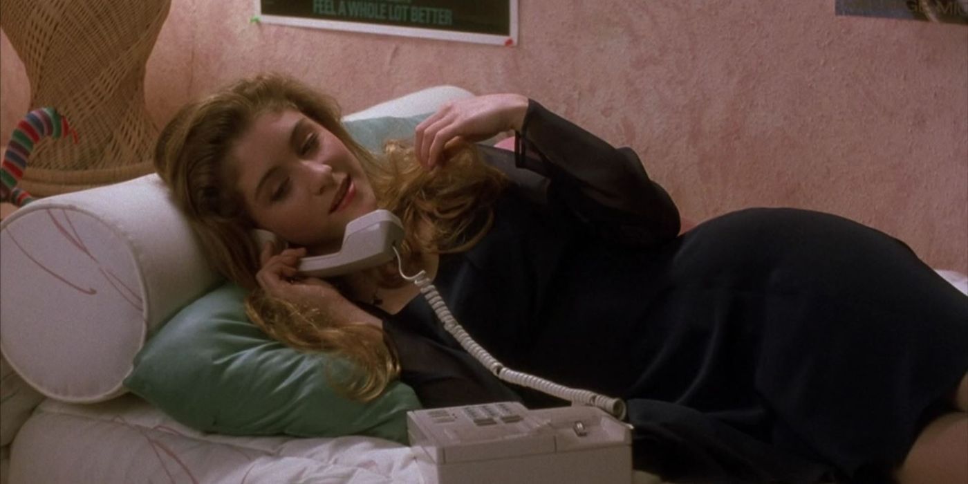 Staci Keanan lies on a chaise couch while talking on a landline phone