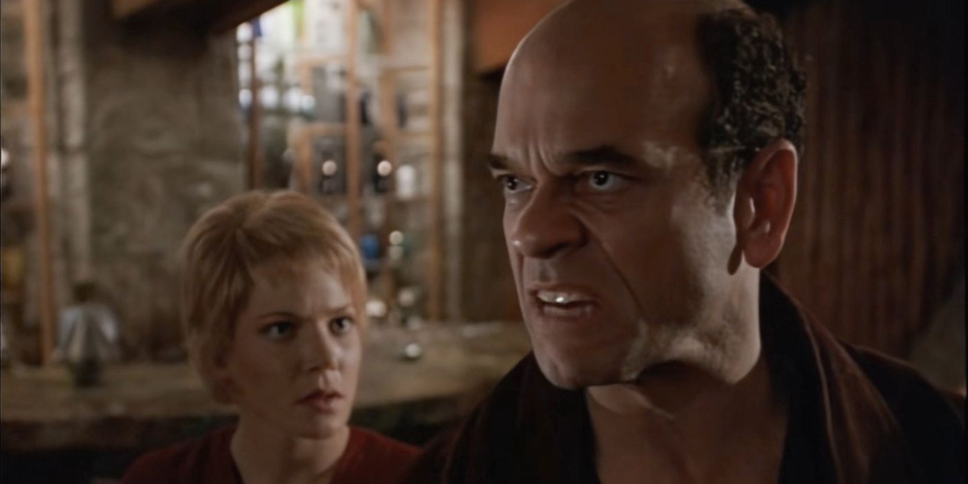 The doctor looks angry and a worried crewmate is in the background staring at him in Star Trek: Voyager.