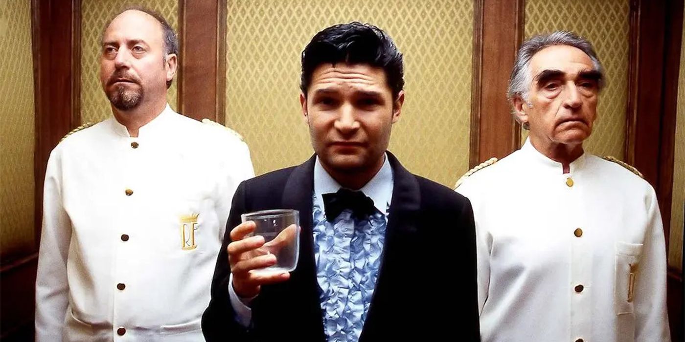 Norman Forrester (Corey Feldman) in an elevator with a drink and two somber men behind him