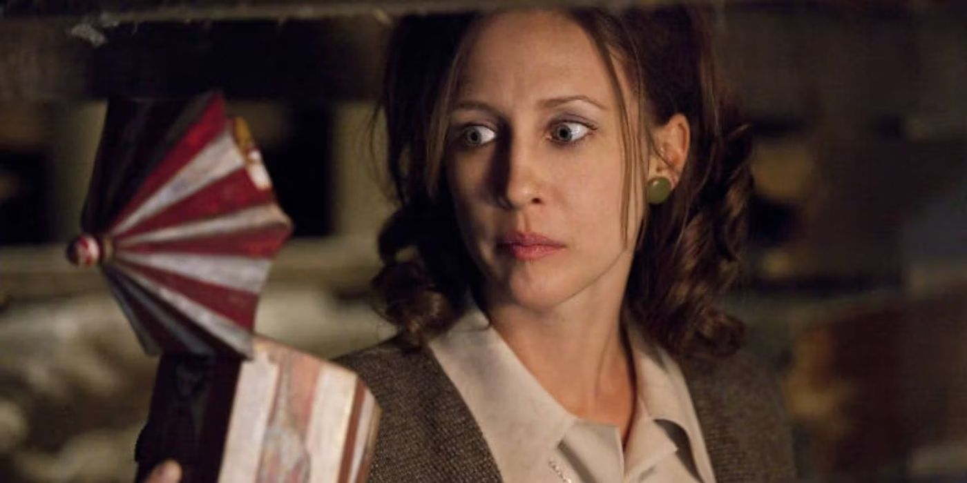 A close-up of Vera Farmiga in The Conjuring looking apprehensively at a music box.