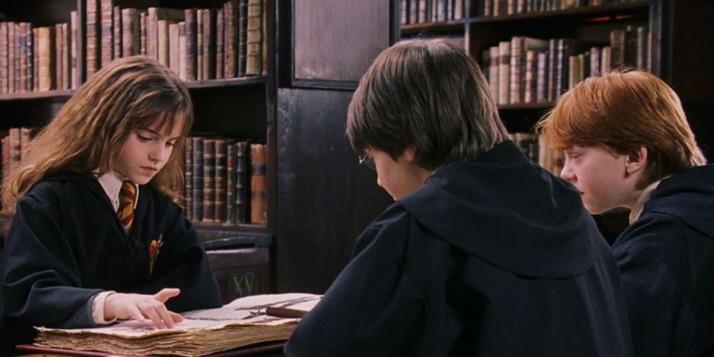 The Golden Trio in the Hogwarts library in 'Sorcerer's Stone'