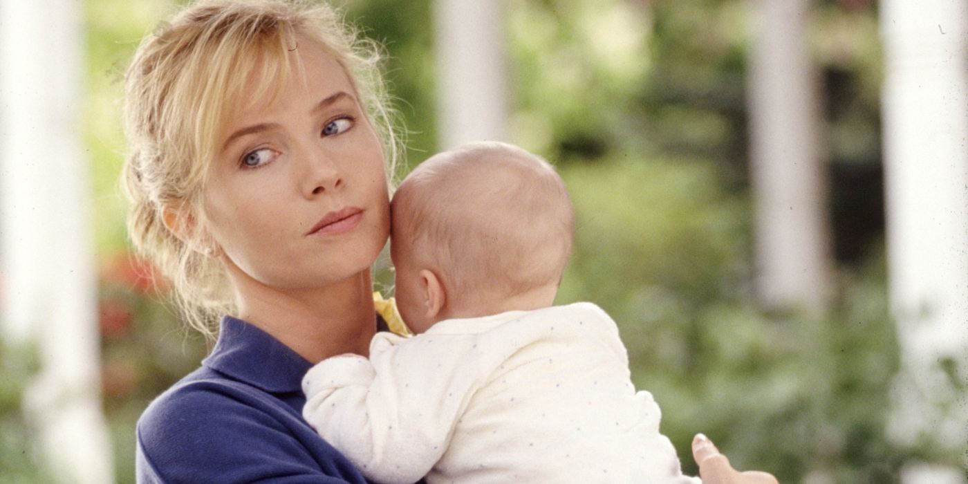 Rebecca De Mornay's Mrs. Mott holding a baby in The Hand That Rocks the Cradle