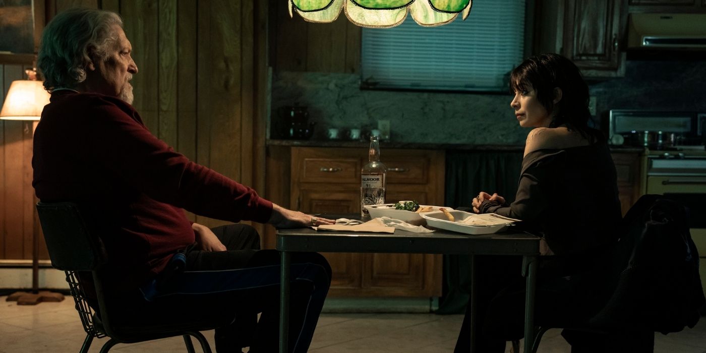 Cristin Milioti and Clancy Brown sitting at a table in a safehouse