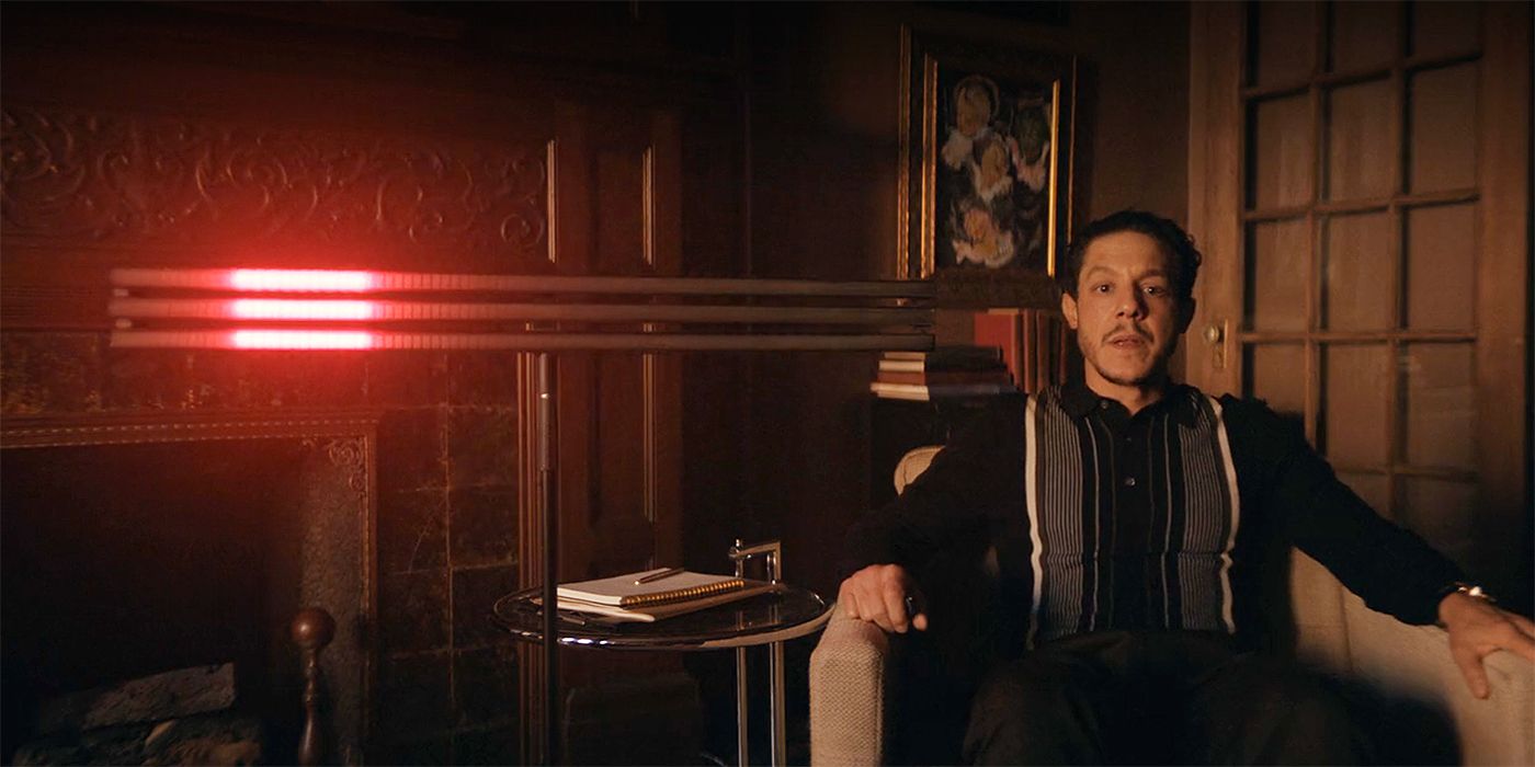 Theo Rossi as Dr. Julian Rush standing next to a red light that he uses to hypnotize his patients in The Penguin