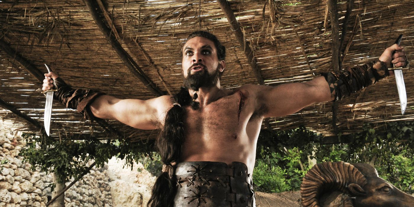 Khal Drogo stands victorious holding knives in outstretched arms in Game of Thrones episode The Pointy End