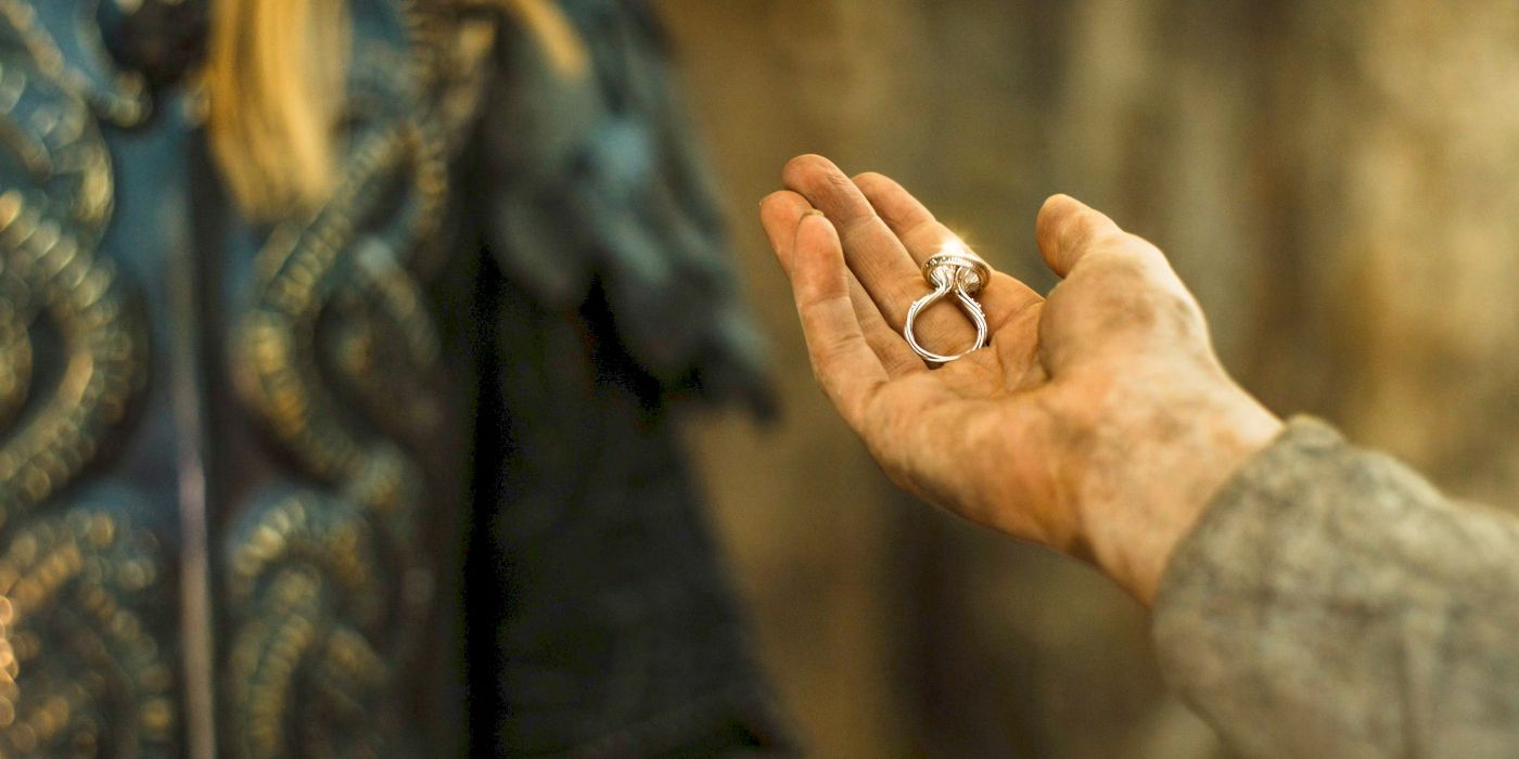 Galadriel (Morfydd Clark) holding her Ring of Power in her palm and extending it out toward Sauron (Charlie Vickers) in The Rings of Power Season 2 finale