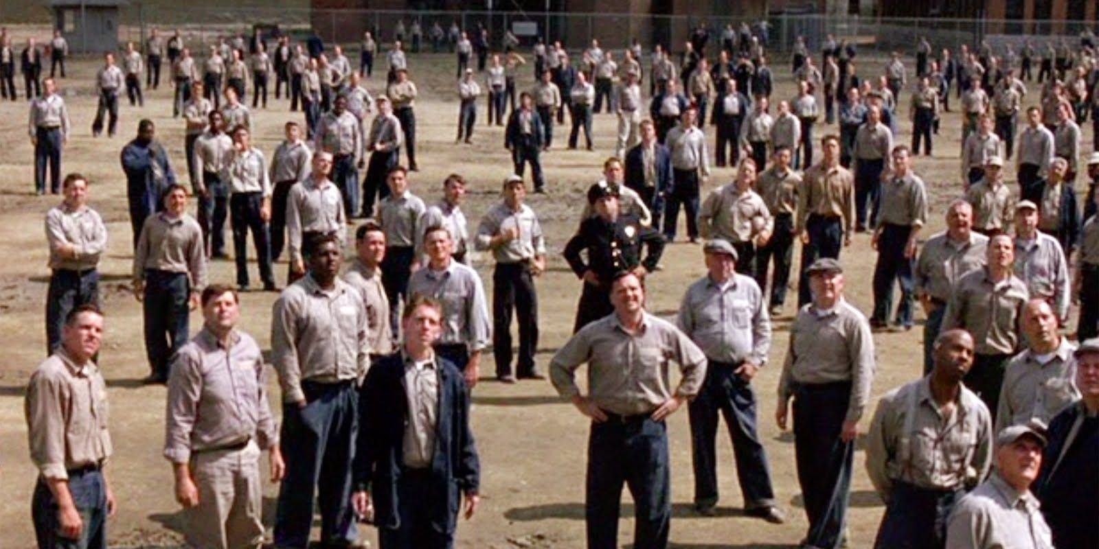 A courtyard full of prisoners looks up in The Shawshank Redemption.