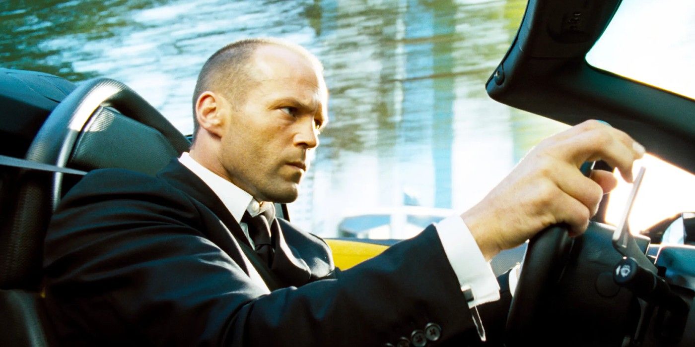 Jason Statham as Frank Martin drives a car and looks serious in The Transporter.